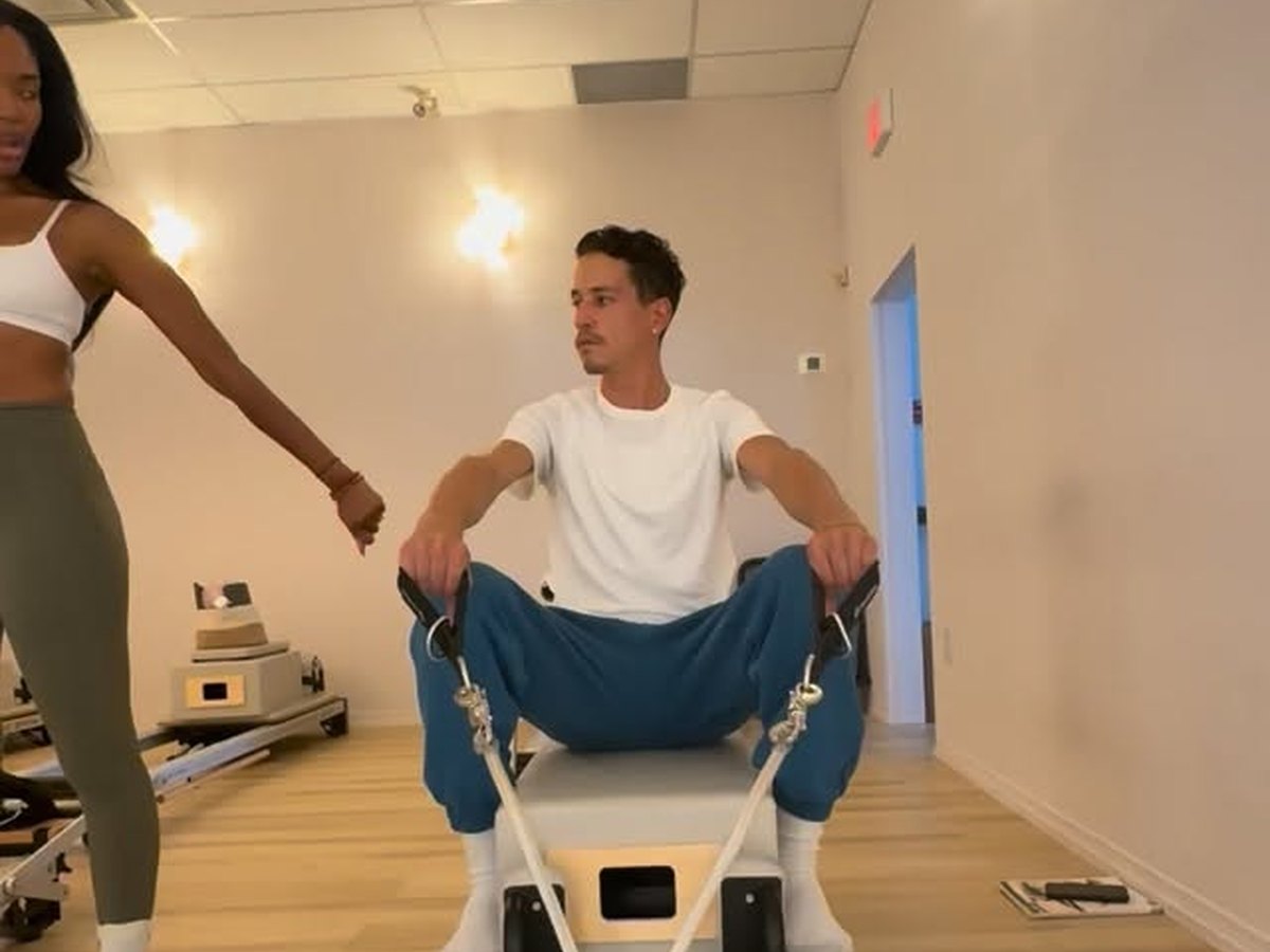 Ruqayyah teaching a client on the chair
